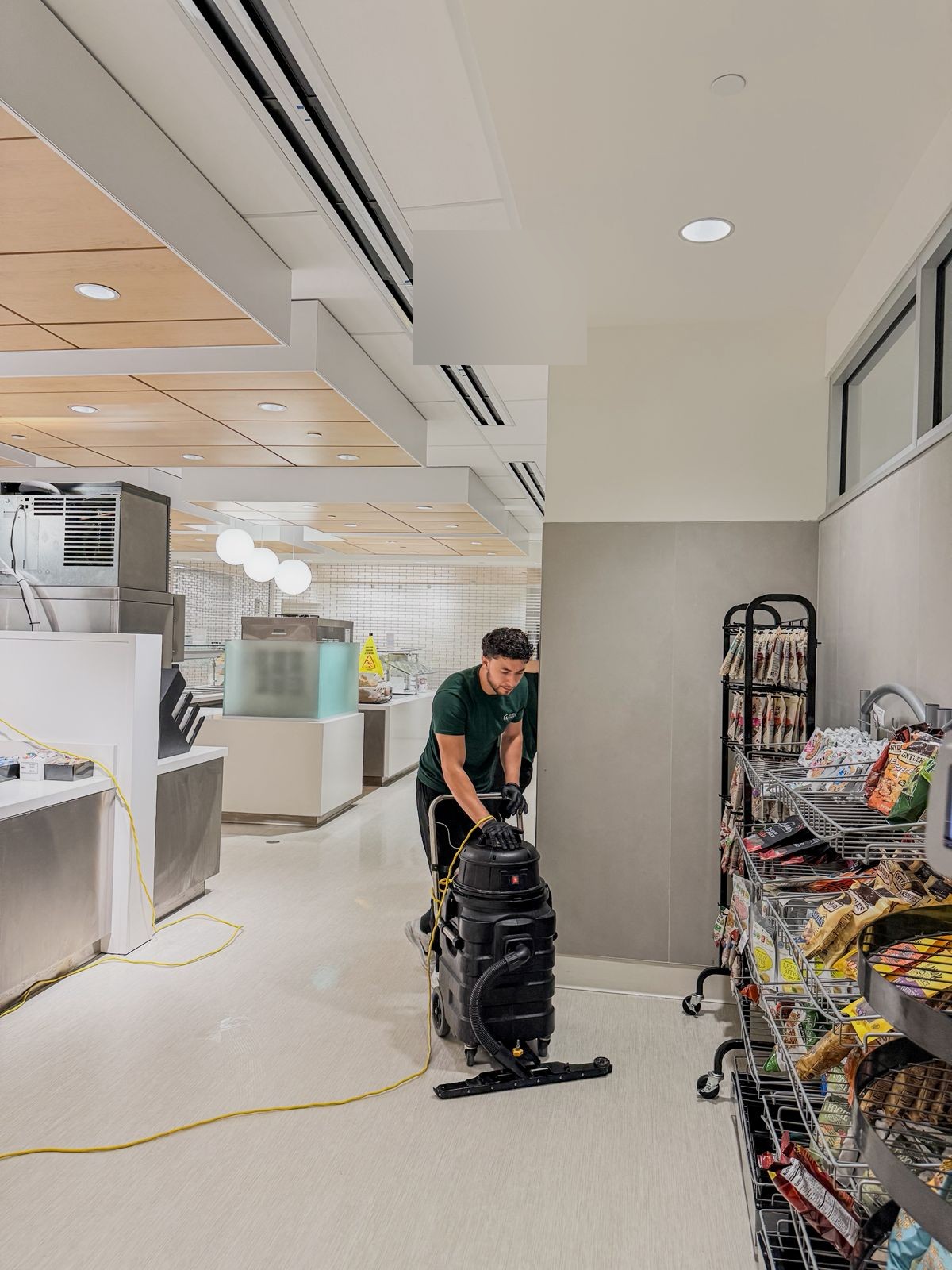 R Megal team member vacuuming commercial space